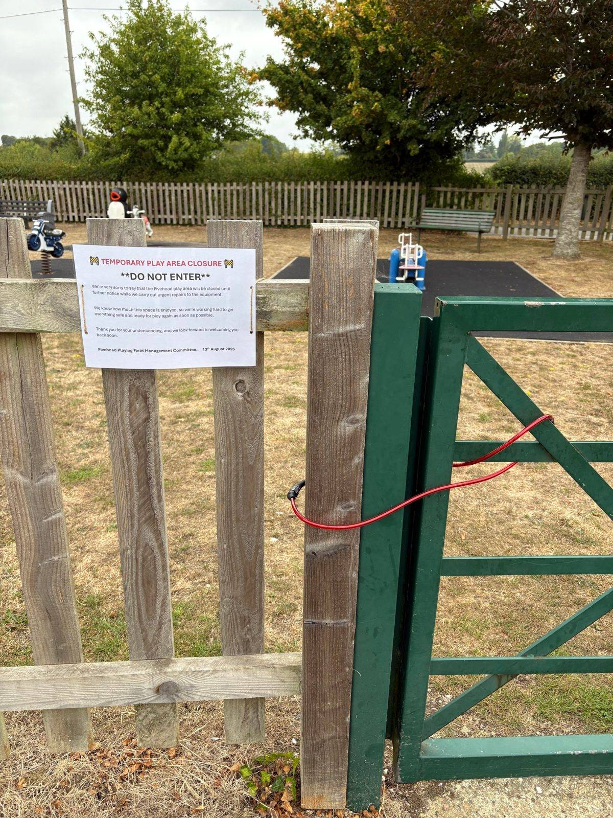 Temporary play area closure notice on the gate, 13 August 2025